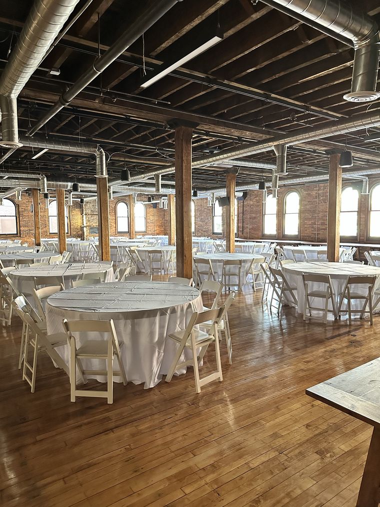 Round tables arranged between the original timber posts