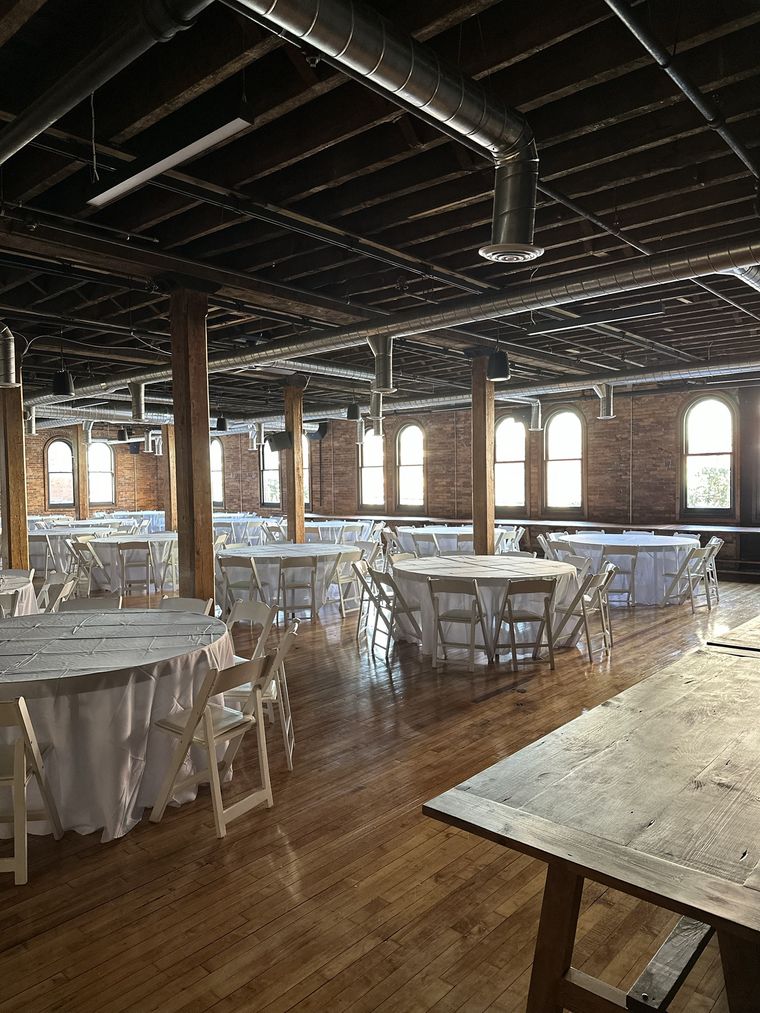 Tables in white linen beneath the tall windows